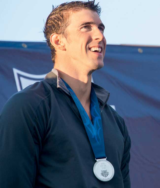 Michael Phelps with his silver medal for men