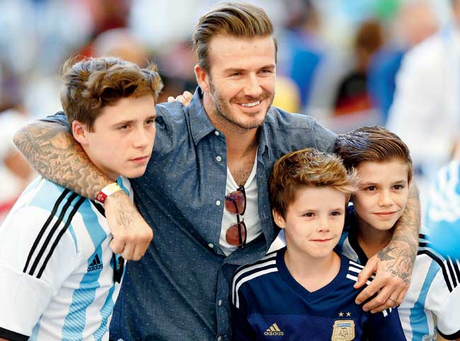 David Beckham with his sons Brooklyn (left), Cruz (second from right) & Romeo (right) during the 2014 FIFA World Cup in Brazil last month
