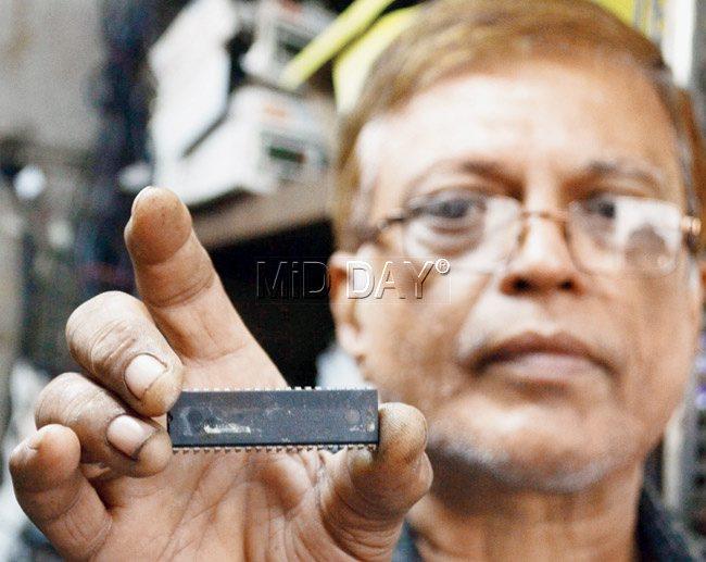 B Jamal, a meter dealer, displays a new chip with revised fares programmed into it, which will be installed in e-meters before the fare hike. Pic/Datta Kumbhar
