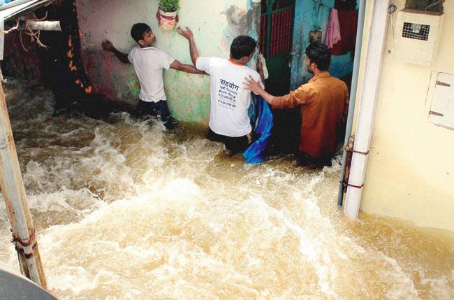 UNDERWATER HOME: The force of the water was so powerful that more than 150 shanties were flooded within minutes of the pipeline bursting. Pic/PTI