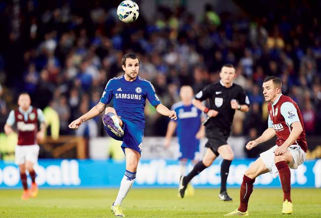 Cesc Fabregas controls the ball during Chelsea