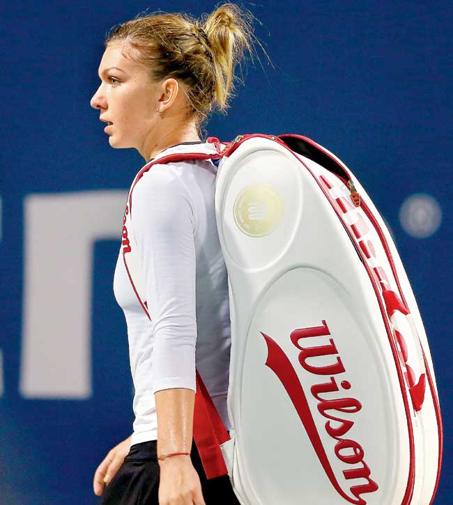 Simona Halep walks away after losing to Magdalena Rybarikova