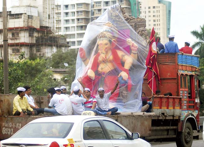 Motorists often complain about tempos carrying Ganpati idols hogging the road and going slow. Pic for representation