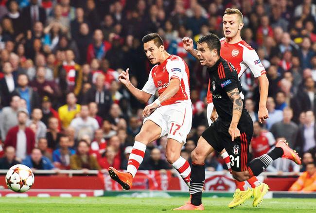 Arsenal-s Alexis Sanchez left shoots to score against Besiktas during the second leg of their UEFA Champions League qualifier at the Emirates Stadium in London on Wednesday. Arsenal won 1-0 and progressed on aggregate as the first leg had ended 0-0. Pic/Getty Images