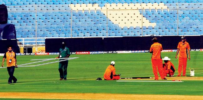 Workers give finishing touches to the DY Patil Stadium before an IPL match in 2010