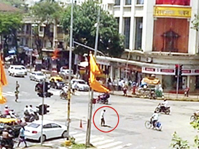 Video grabs show a BMC worker ‘fixing’ potholes outside Sena Bhavan in Dadar