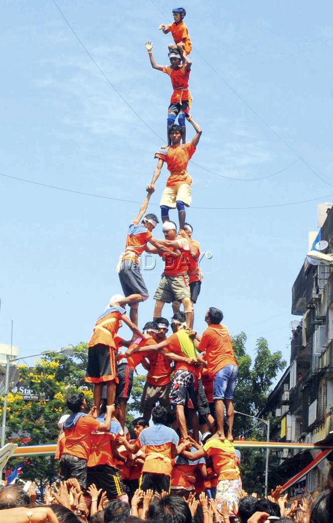 A pyramid being built as an attempt is made to break a pot during a practice session in Dadar