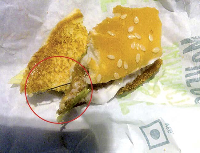 The sharp piece of metal wire sticking out of the patty