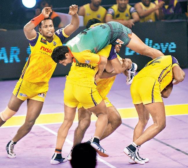 Players of Telugu Titans (in yellow) and Patna Pirates in action