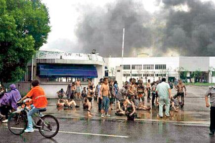 Two officials held in China factory blast