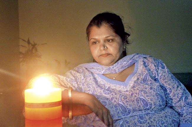 After the BMC disconnected their power and water supplies, residents continue to live in their homes, using candles and the society washroom. File pic