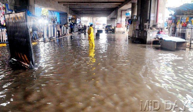 Water, water everywhere: No, there really isn’t a drop to drink. That’s  probably what this Mumbaikar was contemplating below Andheri Metro  station yesterday. Pic/Nimesh Dave