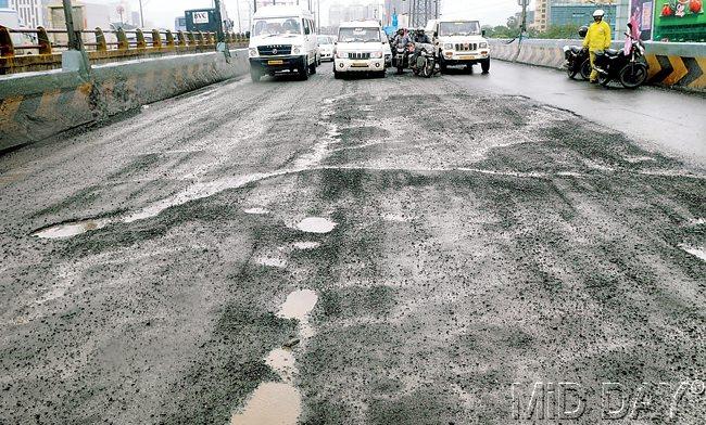 POTHOLES PART TWO: More than 15 potholes are seen on the southbound stretch of the Dindoshi flyover. Pic/Nimesh Dave