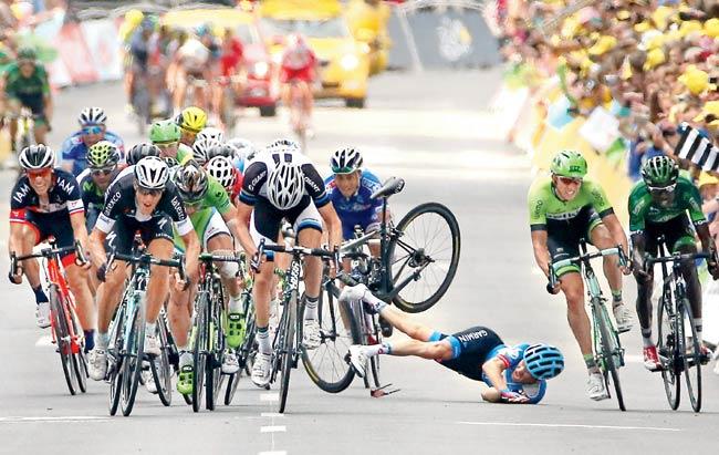 Andrew Talansky of Garmin-Sharp crashes near the finish line in stage seven in Nancy