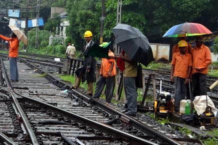 Railway workers repair broken track at Mulund station