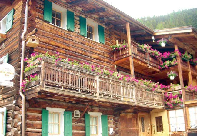 Flower power: Flower boxes full of summer blooms line windows and balconies in homes across the Swiss countryside. Pics/Shiboli Chatterjee