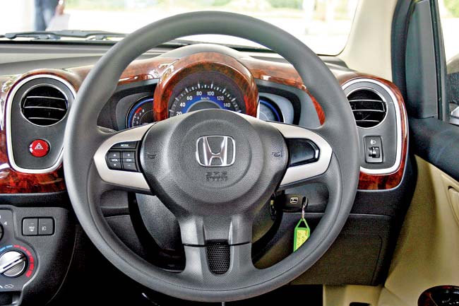 The chunky steering wheel with a wire mesh bottom spoke looks sporty. MID in the instrument cluster lacks a distance to dry readout