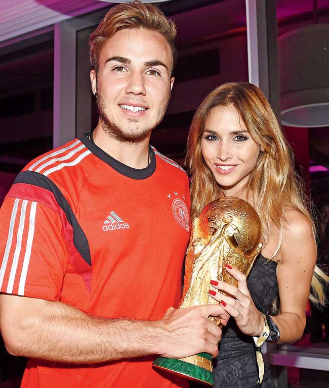 Mario Gotze and girlfriend Ann-Kathrin Brommel pose with the World Cup on July 13. Pic/Getty Images
