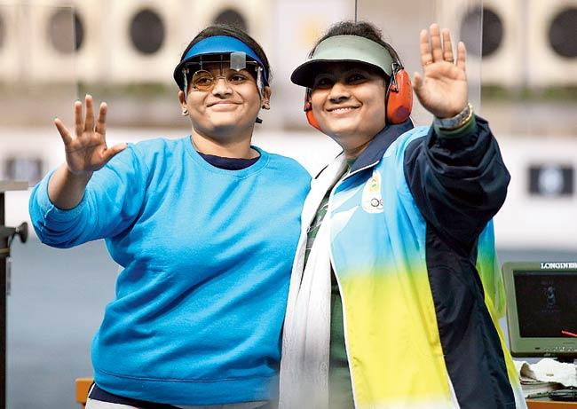 Gold medallist Rahi Sarnobat (left) and silver medallist Anisa Sayyed acknowledge the crowd at the end of the women