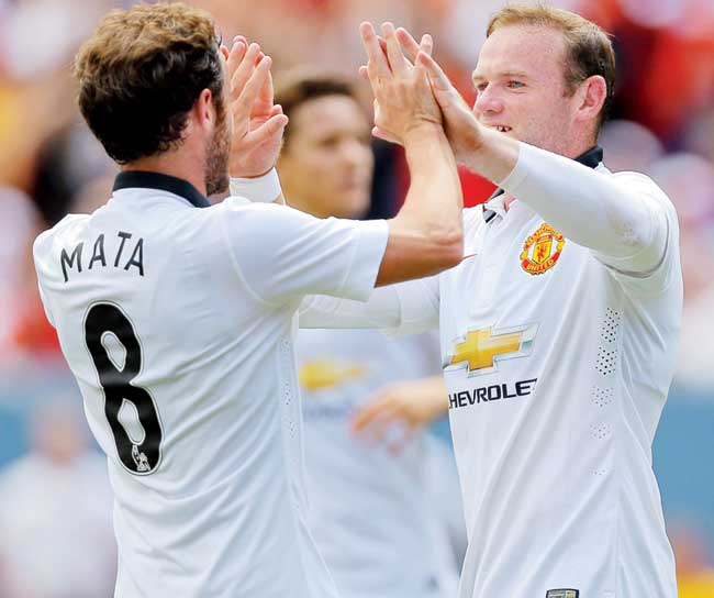 Wayne Rooney and Juan Mata celebrate a goal on Saturday. Pic/Getty Images