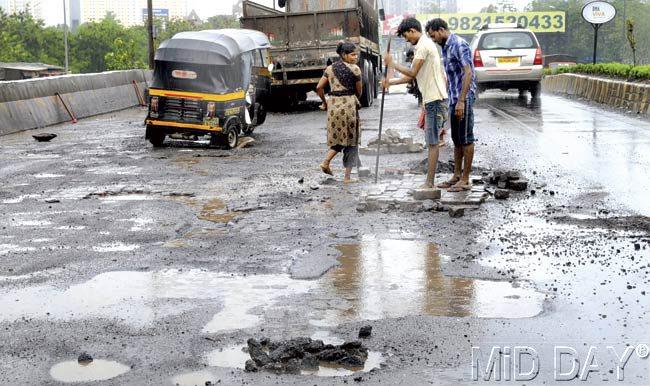 Potholes are a perpetual pain during the monsoon for commuters in Mumbai. Pics/Nimesh Dave