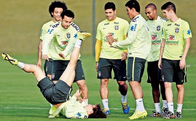 (Left to right) Marcelo, Fred, David Luiz, Hulk, Paulinho, Fernandinho and Oscar have some fun during a training session at Granja Comary. Pic/Getty Images 