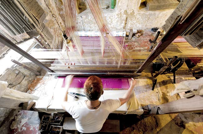 A weaver at work at a handloom.