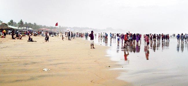 Baga beach with tourists forced to stay away from the rough sea during the monsoons