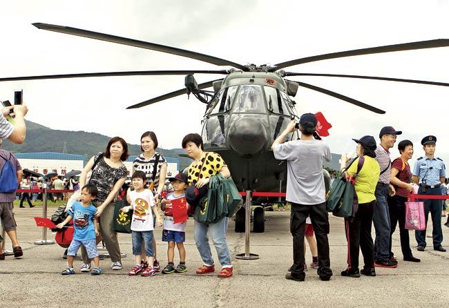 Visitors pose for photographs during an open day at the Chinese People’s Liberation Army (PLA) Shek Kong Barracks in Hong Kong on June 29. The Hong Kong Garrison includes elements of the PLA’s Ground Force, Navy and Air Force, representing a total of around 6,000 personnel. Pic/AFP