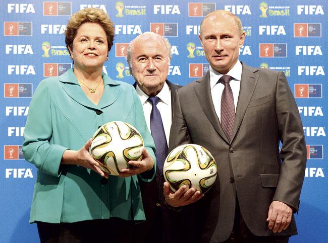 Dilma Rousseff with Sepp Blatter and Vladimir Putin. Pic/AFP