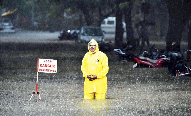 The BMC had to open manholes to allow faster drainage of water. Pic/PTI