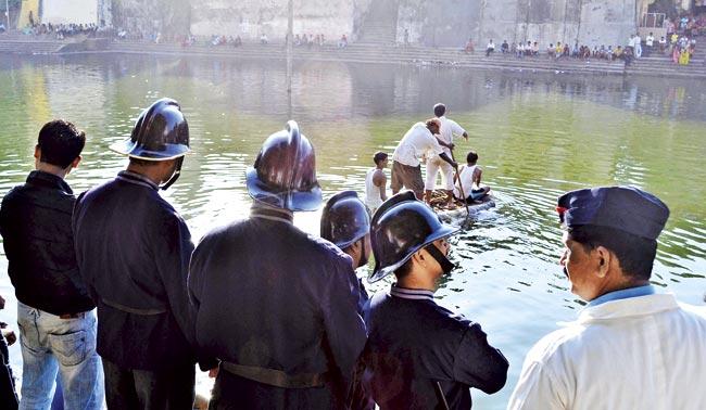 Fire brigade personnel look on as a drowning man is rescued at Banganga. File pic