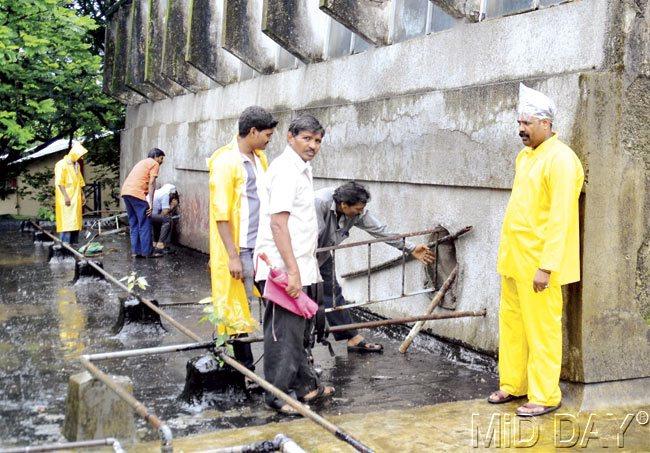 Forest department workers inspect the place from which the leopard entered the metallurgy lab