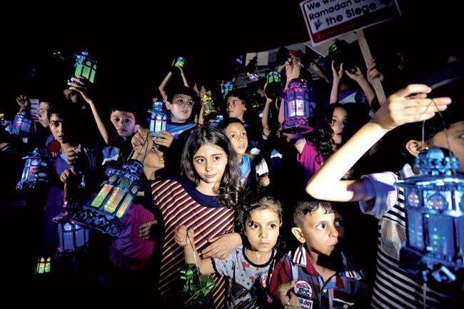 Palestinian children carry traditional Ramadan lanterns in Gaza city, on June 28, during a demonstration against the seige on the Gaza strip, a day before the beginning of the Muslim holy month of Ramadan. Pic/AFP