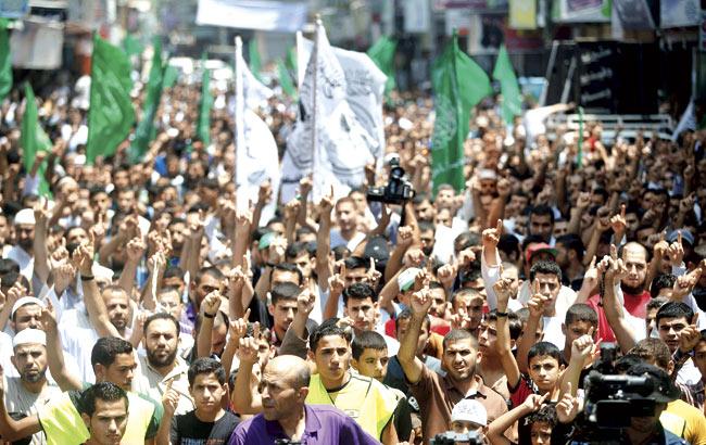Palestinian Hamas supporters take part in a demonstration against the Israeli attacks on the Gaza Strip in the Jabalya refugee camp, in northern Gaza, on July 4. Pic/AFP