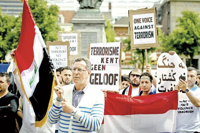 People take part in a demonstration against the violent uprising of the jihadist group of the Islamic State of Iraq and the Levant (known as ISIL or ISIS), in the centre of The Hague, on June 29. The ISIL declared a ‘caliphate’ — an Islamic form of government last seen under the Ottoman Empire — extending from Aleppo in northern Syria to Diyala in Iraq, rebranding itself the Islamic State. Pic/AFP