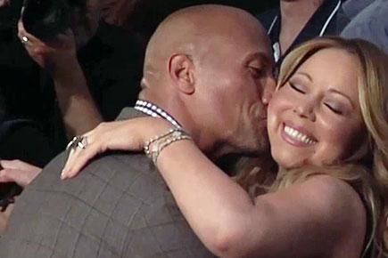 Mariah Carey and Dwayne Johnson kiss at 'Hercules' premiere