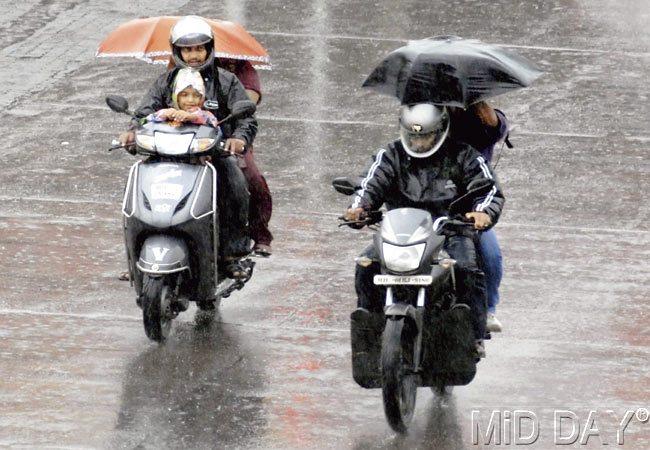 Pillion riders do the best they can to shelter themselves