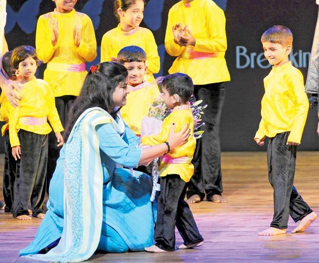 Poonam Mahajan interacts with a kid 