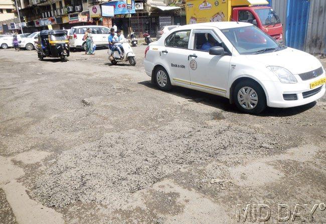 This repair work, commissioned only after mid-day published a report, will barely last a shower or two and the road will be back to what it was. Pics/Suresh KK