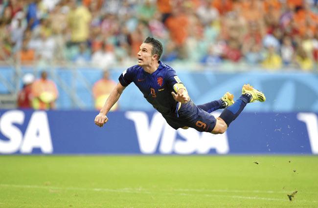 Up, up to the sky. Netherlands’ forward Robin van Persie scores during a match between Spain and the Netherlands during the 2014 FIFA World Cup