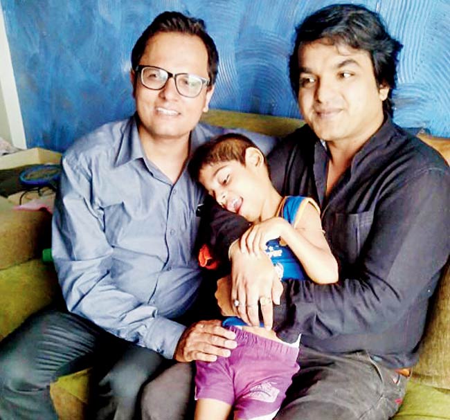 Dr Sourabh Sareen (left) and Dr Roopesh Singh with a cerebral palsy patient