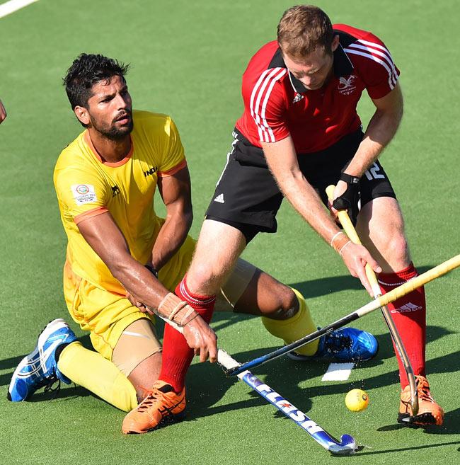 Rupinder Singh vies for the ball with Richard Gay