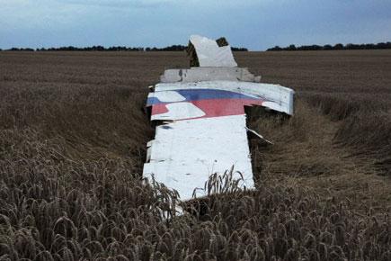 Ukraine workers say 21 bodies found at MH17 crash site