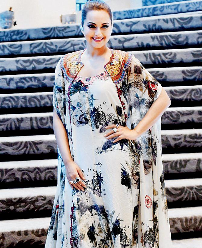 Sonakshi Sinha The actress flaunted a dressy summer look with this printed draped dress, which was paired with a matching cape with detailing near the neck. The statement ear cuffs added to her charm. 