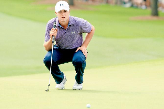 Jordan Spieth lines up a putt on the first green. PIC/AFP