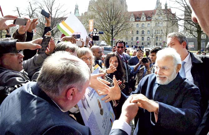 Prime Minister Narendra Modi meets people on his arrival in Hannover on Sunday. The PM’s focus is going to be to reach out to German industry to cooperate with India on several of his pet projects like Make in India, Clean India, etc. Pic/PTI
