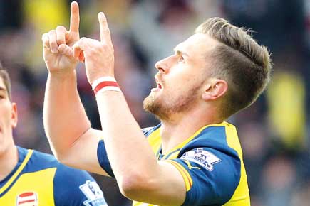 EPL: Wenger upbeat about title after Ramsey strike