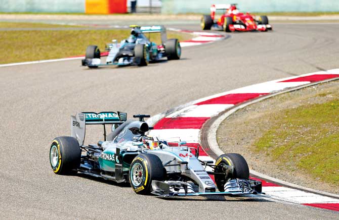 Lewis Hamilton of the Mercedes team makes a turn as he leads teammate Nico Rosberg, who is followed by Ferrari
