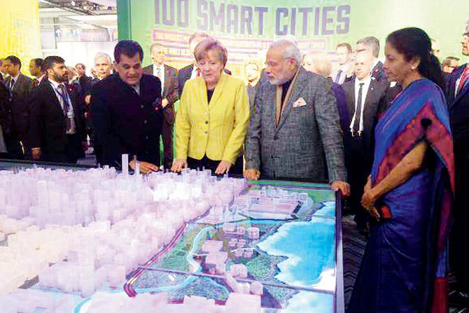 Amitabh Kant with Prime Minister Narendra Modi and Chancellor Angela Merkel